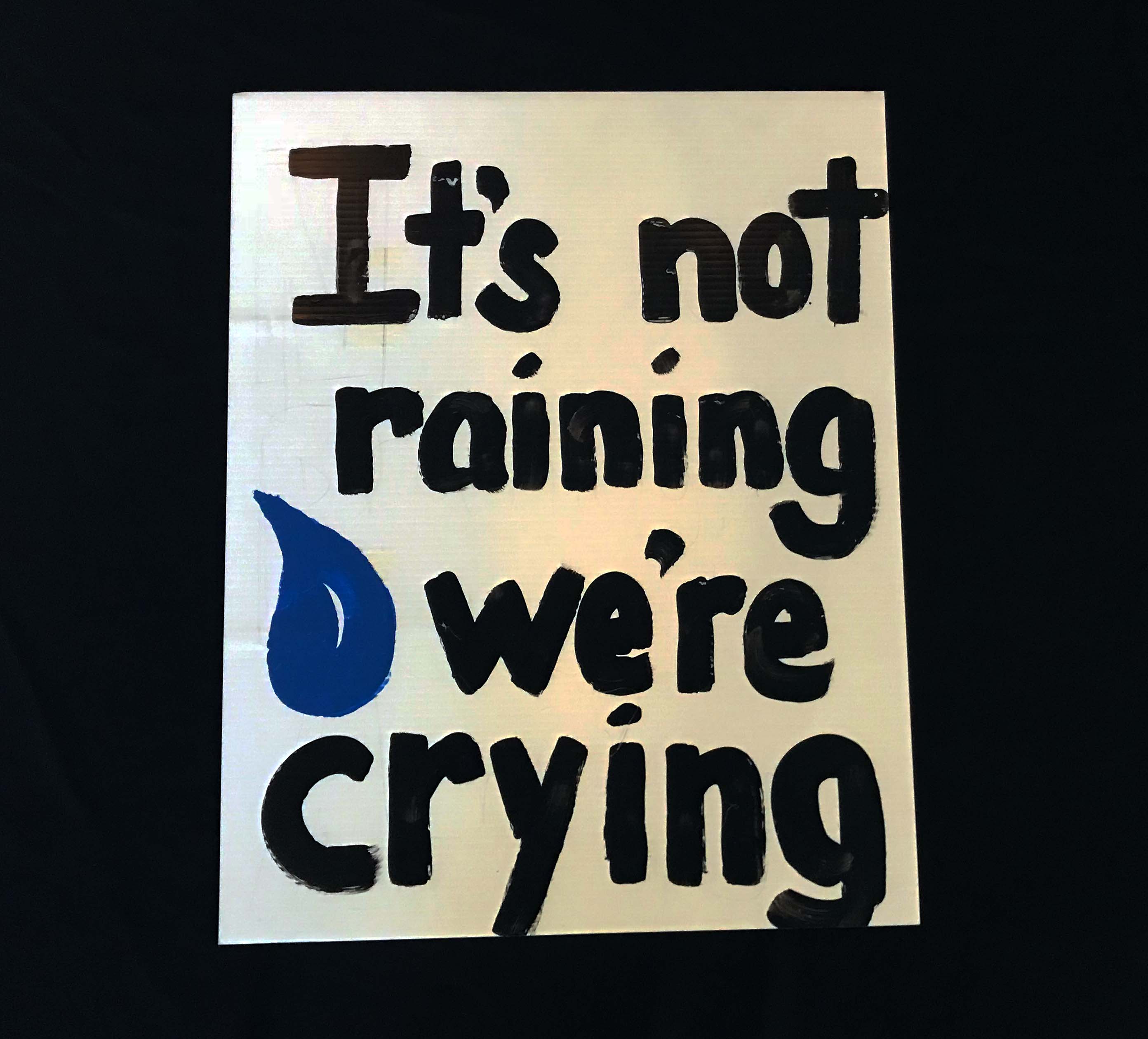 Charlotte March for Our Lives, 2018. Sign reads: "It's not raining, we're crying."