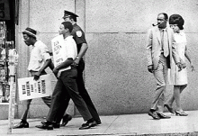 Protesters demonstrate for stronger desegregation measures.