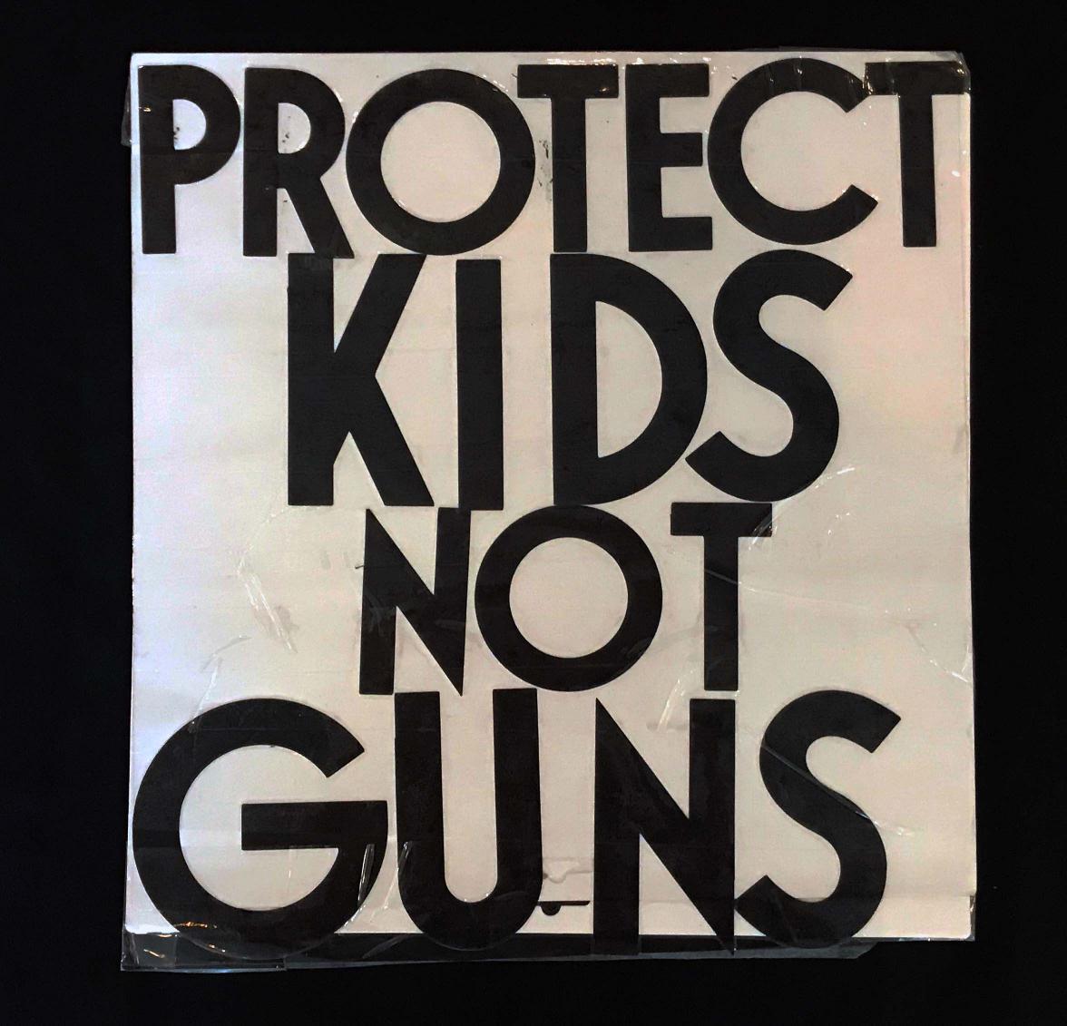 Charlotte March for Our Lives, 2018. Sign reads: "Protect kids, not guns."