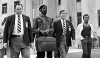 T. J. Reddy, (with suitcase) leaves the courthouse with fellow defendant Charles Parker
